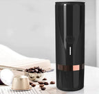 Black coffee maker with a power button on a light gray background